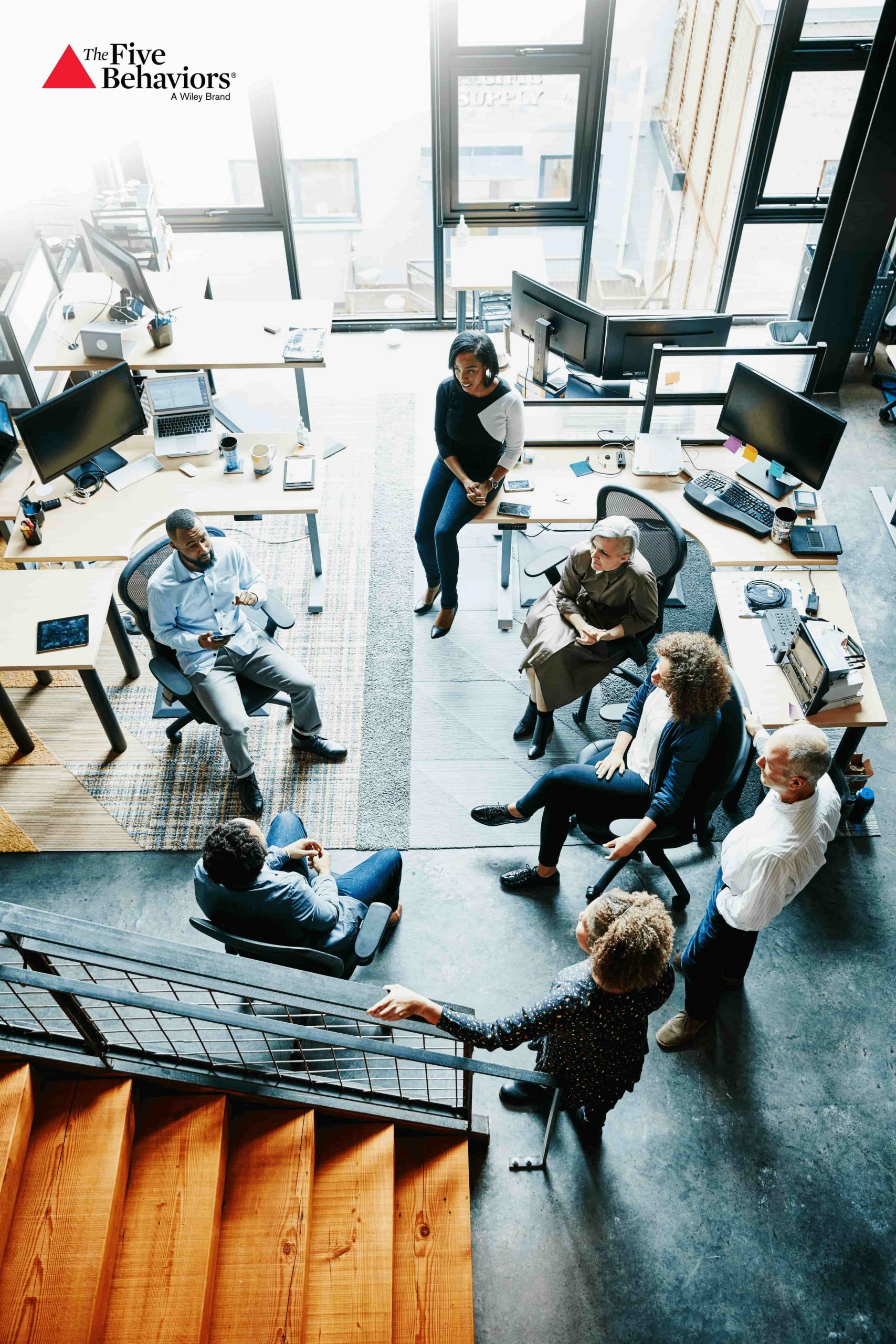 Seven people in a room having a business meeting.