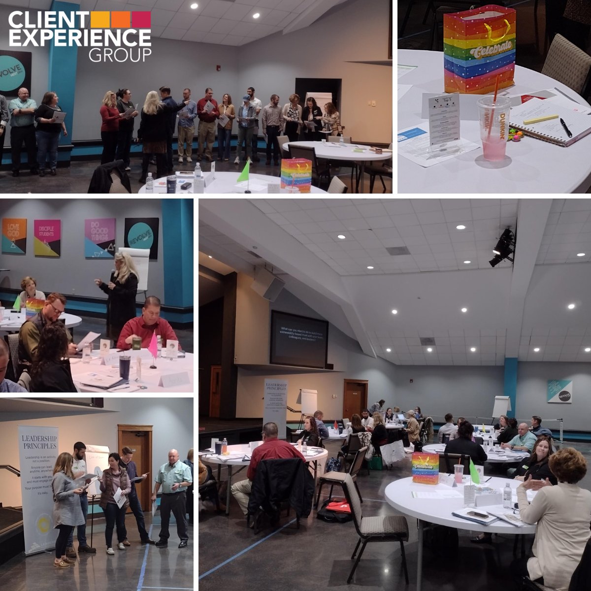 Participants sitting at round tables during The Five Behaviors® Personal Development workshop. Participants also standing as they engage in the workshop learning activities.